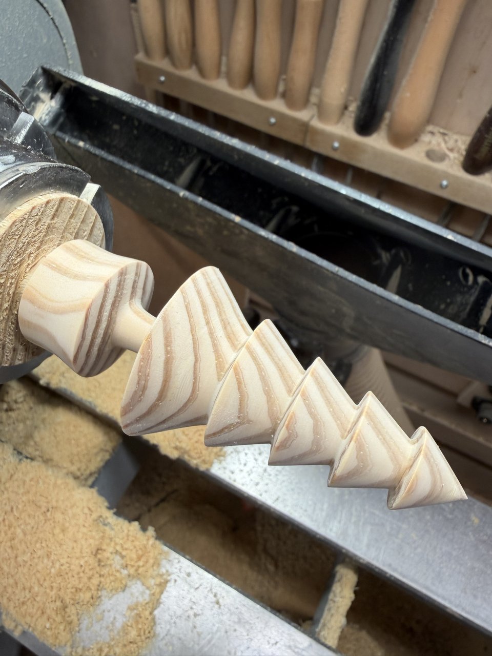 A larch tree taking shape on the lathe, the grain sweeping round each bough